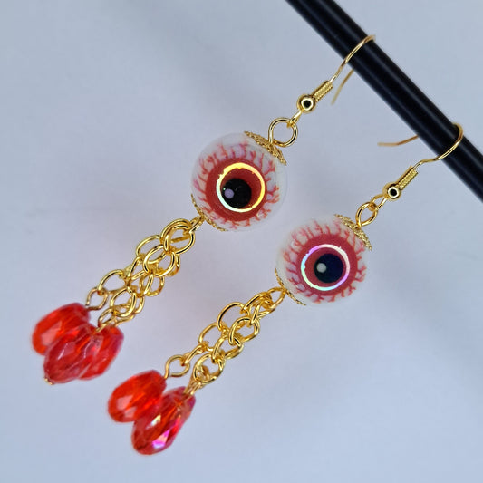 Red eyeball gold tone stainless steel earring
