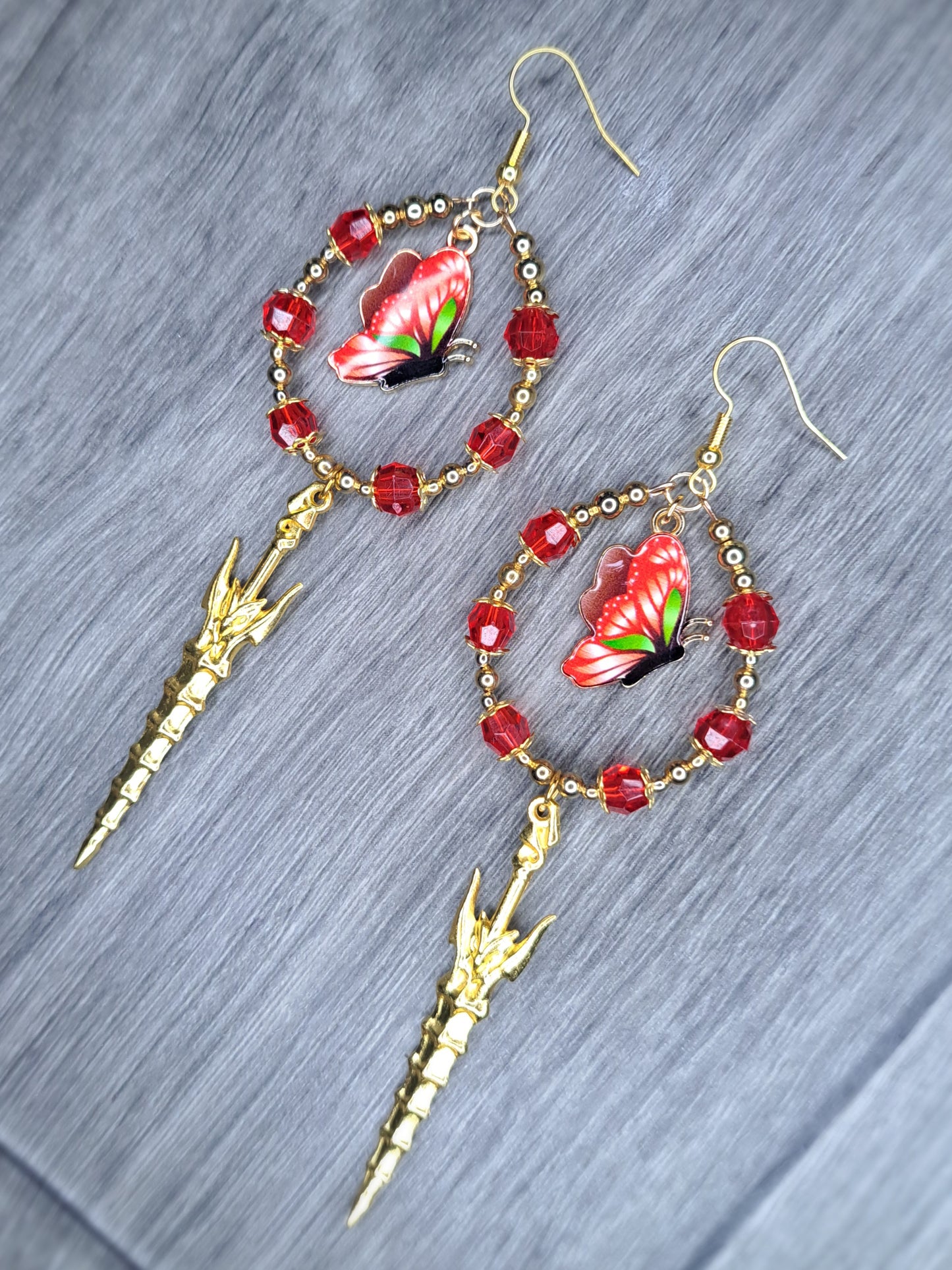 Red beaded silver sword butterfly hoop earrings