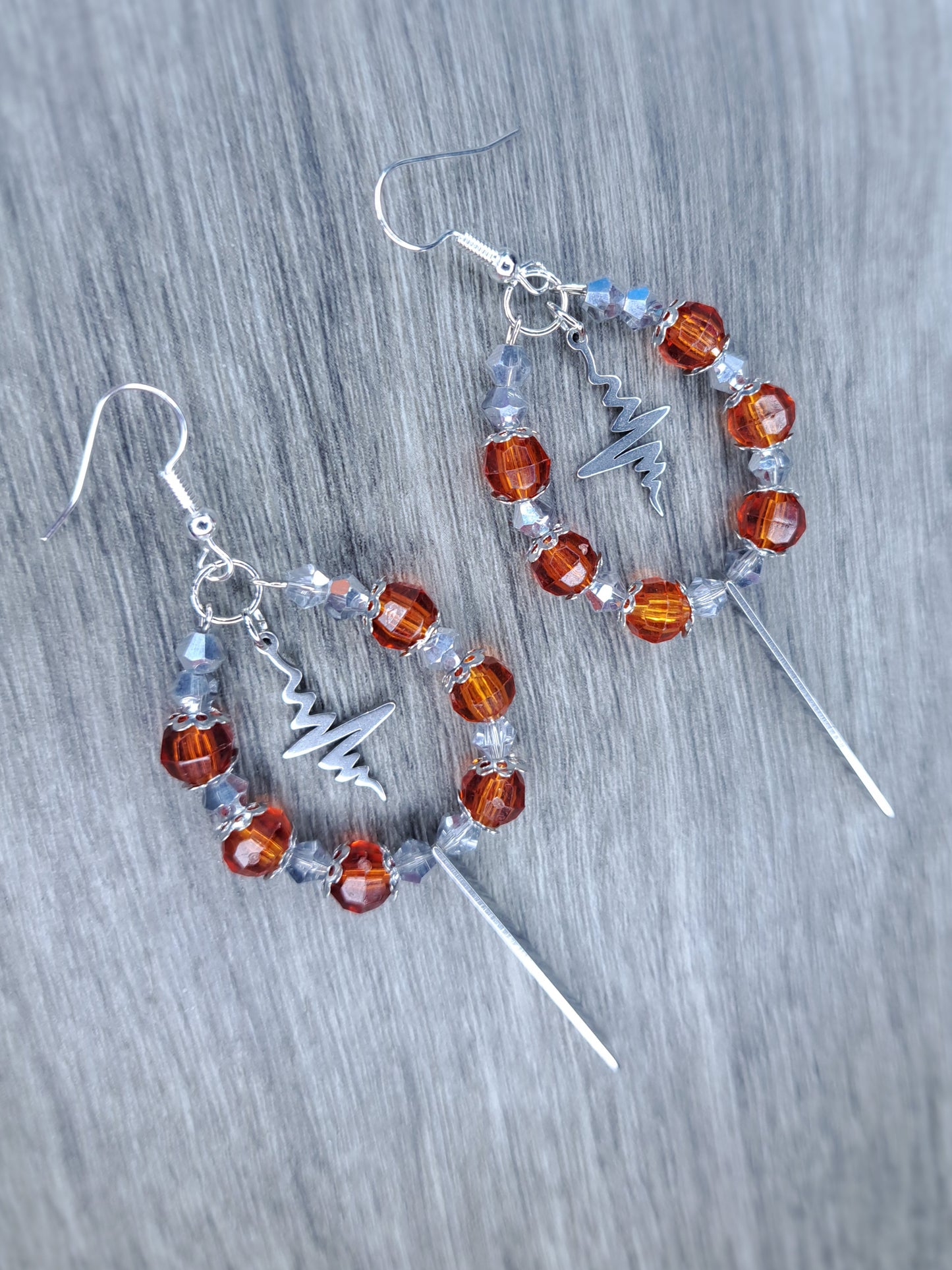 Orange and silver dangly hoop sword earrings