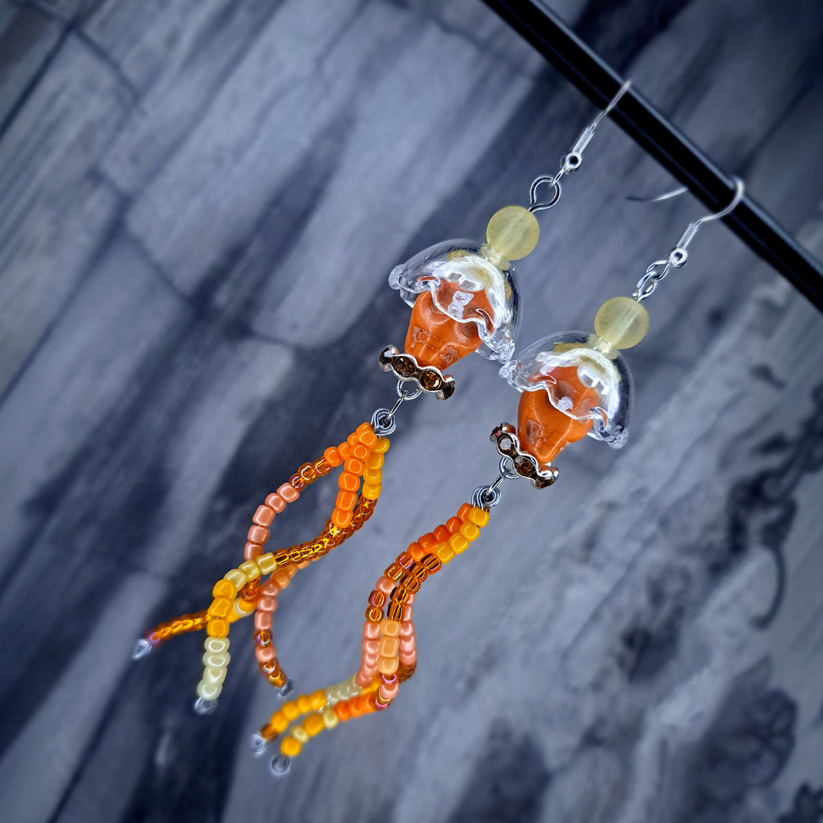 Orange howlite skull jellyfish stainless steel earrings
