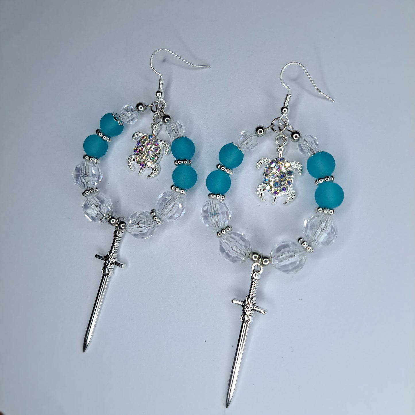 clear and turquoise beaded stainless steel hoop sword earrings